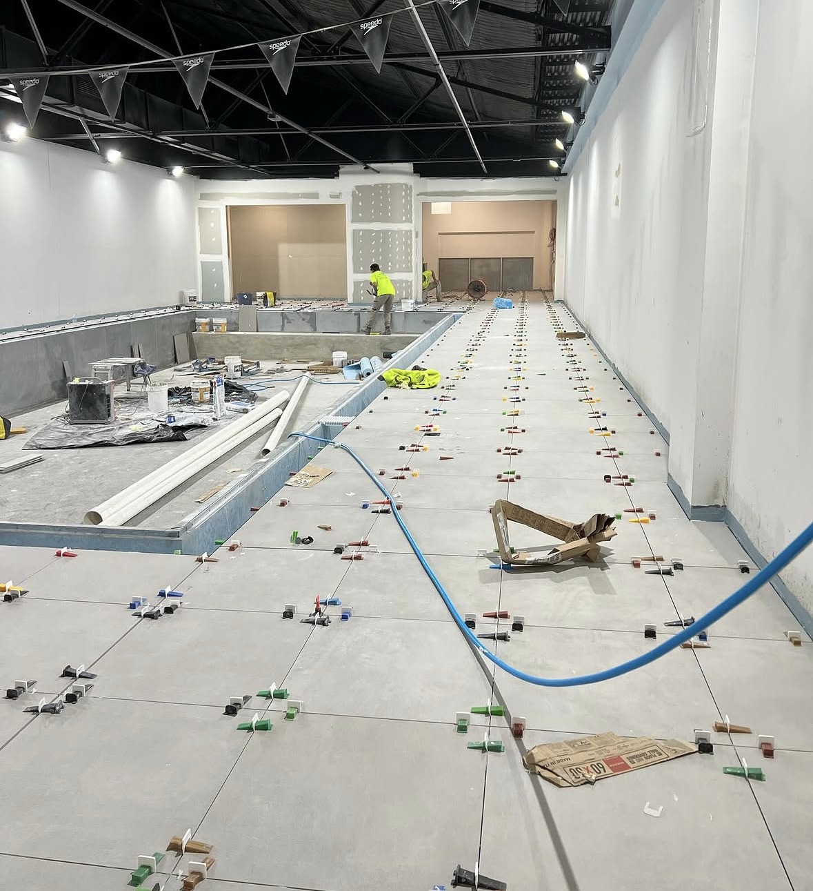 Large-Format Commercial Floor: A large-format floor installation documented from site preparation through to the finished surface.